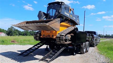 how to load a skid steer on a dump trailer|skid steer trailer hitch attachment.